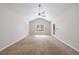 Main bedroom featuring vaulted ceiling, ceiling fan, and door to back yard at 1830 Broadway St, Decatur, GA 30035