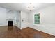 Dining room with wood floors, wainscoting, window and view of fireplace and vaulted ceiling at 1830 Broadway St, Decatur, GA 30035