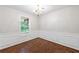 Bright dining room with wood floors, chandelier, large window and detailed chair railing at 1830 Broadway St, Decatur, GA 30035