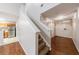 Hallway with a staircase, hardwood floors, and access to kitchen, and front door at 1830 Broadway St, Decatur, GA 30035