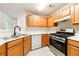 Kitchen featuring stainless steel appliances, oak cabinets and white countertops at 1830 Broadway St, Decatur, GA 30035