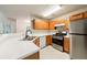 Kitchen with stainless steel appliances, white counters and oak cabinets at 1830 Broadway St, Decatur, GA 30035