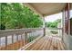 A cozy outdoor porch with wood decking and white railings, offering an inviting space to relax and enjoy the view at 1830 Broadway St, Decatur, GA 30035