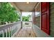 Outdoor porch with white railings, wood decking, and red shutters, offers an inviting space to relax and enjoy the view at 1830 Broadway St, Decatur, GA 30035
