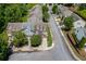An aerial view of townhomes reveals neat landscaping, mature trees, and the end of a cul-de-sac at 2421 Elkhorn Ter, Duluth, GA 30096