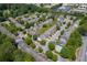 Aerial view showing a neighborhood that includes a community pool, trees, and access to a thoroughfare at 2421 Elkhorn Ter, Duluth, GA 30096