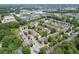 An aerial view shows the property nestled among trees and close to commercial development at 2421 Elkhorn Ter, Duluth, GA 30096