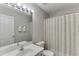 Bathroom with a single sink, tile floors, and a curtained shower/tub combination at 2421 Elkhorn Ter, Duluth, GA 30096