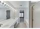 Bright bathroom featuring double sinks, vanity with lighting, and shower with glass door at 2421 Elkhorn Ter, Duluth, GA 30096
