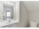 The bathroom features a vanity with a mirror, a toilet, and a doorway to another room at 2421 Elkhorn Ter, Duluth, GA 30096