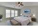 Bright bedroom features a large window, ceiling fan, and neutral tones, creating a serene and inviting space at 2421 Elkhorn Ter, Duluth, GA 30096