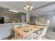 The dining room offers wainscoting, modern lighting and flows into the living room and kitchen at 2421 Elkhorn Ter, Duluth, GA 30096