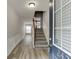 Inviting foyer with hardwood flooring, staircase, and natural light streaming through the front door's window at 2421 Elkhorn Ter, Duluth, GA 30096