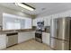 The kitchen boasts stainless steel appliances, granite counters, tile backsplash, and white cabinets at 2421 Elkhorn Ter, Duluth, GA 30096