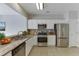 This kitchen has stainless steel appliances, granite countertops, and white cabinetry at 2421 Elkhorn Ter, Duluth, GA 30096