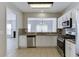 The bright kitchen overlooks the dining area and has stainless steel appliances and granite countertops at 2421 Elkhorn Ter, Duluth, GA 30096
