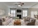 Comfortable living room with a fireplace, ceiling fan, and an open layout connecting to dining area at 2421 Elkhorn Ter, Duluth, GA 30096