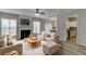 Bright living room features fireplace, neutral walls, and an open layout connecting to the dining and kitchen areas at 2421 Elkhorn Ter, Duluth, GA 30096