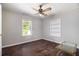 Charming bedroom offers a ceiling fan, built-in shelves, and hardwood flooring at 3530 E Ponce De Leon Ave, Scottdale, GA 30079