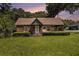 Charming brick home featuring a well-manicured lawn and mature trees at 3530 E Ponce De Leon Ave, Scottdale, GA 30079