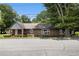This brick home features a neatly maintained yard and shade trees at 3530 E Ponce De Leon Ave, Scottdale, GA 30079