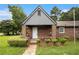 Brick home featuring a cozy front porch and well-maintained landscaping at 3530 E Ponce De Leon Ave, Scottdale, GA 30079