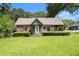 Charming brick home featuring a well-manicured lawn and mature trees at 3530 E Ponce De Leon Ave, Scottdale, GA 30079