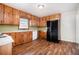 Functional kitchen featuring laminate floors, a refrigerator, and matching cabinetry at 3530 E Ponce De Leon Ave, Scottdale, GA 30079