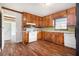 Functional kitchen featuring laminate floors, a refrigerator, and matching cabinetry at 3530 E Ponce De Leon Ave, Scottdale, GA 30079