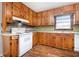 Functional kitchen featuring laminate floors, a stove/oven, and matching cabinetry at 3530 E Ponce De Leon Ave, Scottdale, GA 30079