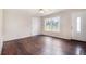 Bright living room featuring hardwood floors, a large window and white walls at 3530 E Ponce De Leon Ave, Scottdale, GA 30079