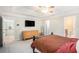 Bedroom with a tray ceiling, dark furnishings, and neutral carpet at 6738 Brookfield Way, Douglasville, GA 30134