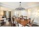 Dining room with hardwood floors, crown molding, and a modern chandelier at 6738 Brookfield Way, Douglasville, GA 30134