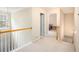 Upstairs hallway with carpet, wood railing, and doorways to bedrooms at 6738 Brookfield Way, Douglasville, GA 30134