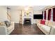 Cozy living room with hardwood floors, fireplace, and comfortable seating at 6738 Brookfield Way, Douglasville, GA 30134