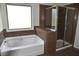 Bathroom featuring a bathtub and glass door shower at 1365 Slate Bend Dr, Dacula, GA 30019
