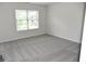 Bright bedroom featuring neutral walls, gray carpet, and natural light from a window at 1365 Slate Bend Dr, Dacula, GA 30019