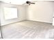 Spacious bedroom with ceiling fan, plush carpet, and neutral wall paint at 1365 Slate Bend Dr, Dacula, GA 30019