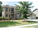 Traditional brick home with a two-car garage, well-maintained lawn, and mature landscaping at 1365 Slate Bend Dr, Dacula, GA 30019