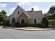 Charming home featuring stone accents, arched windows, manicured landscaping, and a welcoming covered front porch at 1365 Slate Bend Dr, Dacula, GA 30019