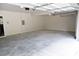 Spacious two-car garage featuring an automatic door and ample room for parking and storage at 1365 Slate Bend Dr, Dacula, GA 30019