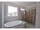Unfinished bathroom with tub and a large window, prepped for customization and finishing touches at 14 Berkten Ct, Hiram, GA 30141