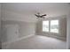 Large bedroom with a ceiling fan, two bright windows, and an access door ready for finishing touches at 14 Berkten Ct, Hiram, GA 30141