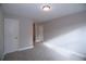 An empty bedroom boasts neutral paint, plush carpet, and features a closet and doorway at 14 Berkten Ct, Hiram, GA 30141