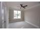 Well-lit bedroom with ceiling fan and a view of the neighborhood at 14 Berkten Ct, Hiram, GA 30141