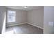A well-lit bedroom features neutral walls, plush carpet, and a window with a view at 14 Berkten Ct, Hiram, GA 30141