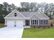 Charming one-story home featuring a two-car garage and well-manicured lawn at 14 Berkten Ct, Hiram, GA 30141