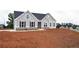 Charming new construction home with gray siding, stone accents, black shutters and landscaping at 14 Berkten Ct, Hiram, GA 30141