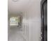 Hallway with white walls, board and batten accents, doors, and views of the living spaces at 14 Berkten Ct, Hiram, GA 30141