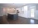 Well-lit kitchen with modern appliances, a large island, and hardwood floors at 14 Berkten Ct, Hiram, GA 30141